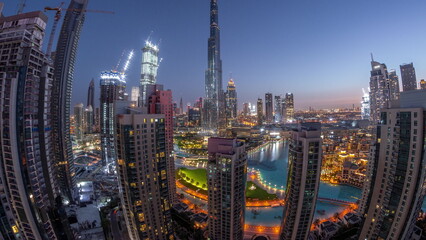 Obraz premium Panorama of Dubai Downtown cityscape with tallest skyscrapers around aerial night to day timelapse.