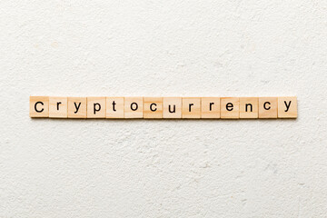 Cryptocurrency word written on wood block. Cryptocurrency text on cement table for your desing, concept