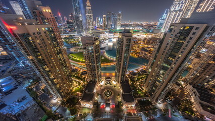 Fototapeta na wymiar Dubai Downtown cityscape with tallest skyscrapers around aerial night timelapse.