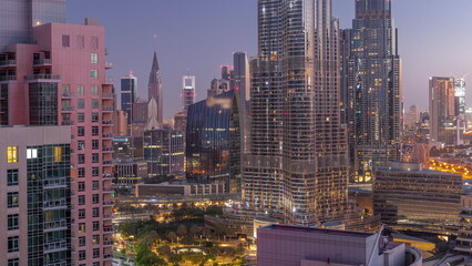 Aerial view of Dubai International Financial Centre district skyscrapers night to day timelapse