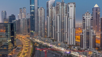 Fototapeta na wymiar Bay Avenue with modern towers residential development in Business Bay aerial night to day timelapse, Dubai
