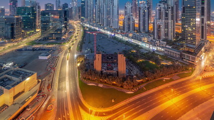 Fototapeta na wymiar Bay Avenue with modern towers residential development in Business Bay aerial panoramic night to day timelapse, Dubai