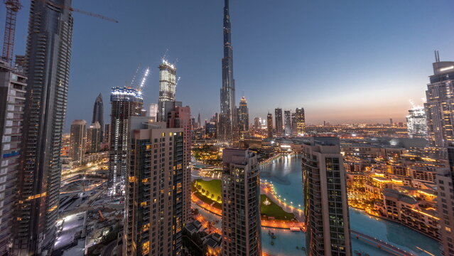 Dubai Downtown cityscape with tallest skyscrapers around aerial night to day timelapse. © neiezhmakov