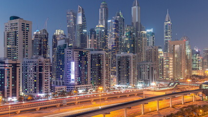 Fototapeta na wymiar Dubai marina tallest block of skyscrapers day to night timelapse.