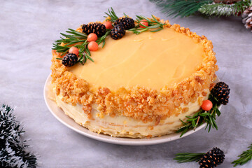 Chopped cake with lemon curd and buttercream decorated with candied pine cones, rosemary and sugar sprinkles