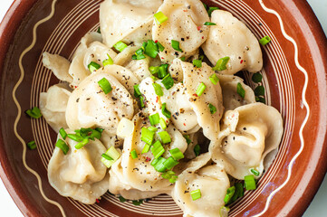 a classic traditional dish of dumplings with meat, butter, pepper and greens, food of the countries of the world, gastrotourism