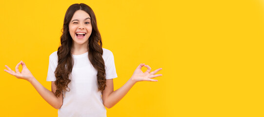 Funny winking teenager child girl in white shirt hold hands in yoga om aum gesture relax meditate...