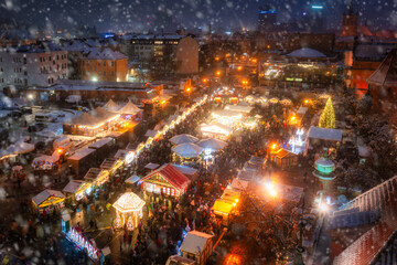 Beautifully lit Christmas fair (pol. Jarmark) in the Main City of Gdansk during a snowfall. Poland
