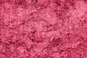 Magenta red concrete cement wall textured weathered and cracked background. Plain viva monochrome backdrop