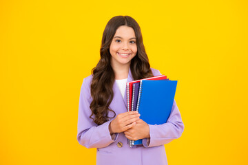 Back to school. Teenager schoolgirl with book ready to learn. School girl children on isolated yellow studio background.