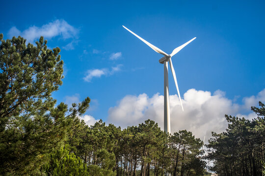 wind turbine close-up view from below against blue sky. Wind power plant. Renewable energy