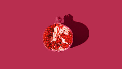 Minimal style composition made of a half of a fresh pomegranate. Refreshment concept. Healthy food...