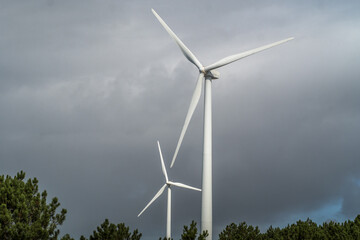 Wind turbines against the cloudy sky. Wind power plant