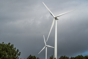 Fototapeta premium Wind turbines against the cloudy sky. Wind power plant