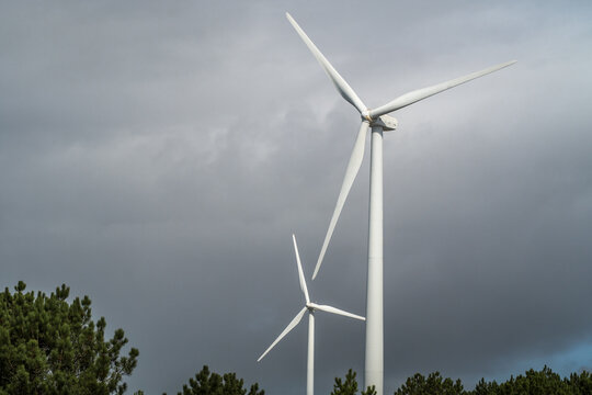 Wind turbines against the cloudy sky. Wind power plant