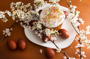 Easter cake, painted egg and blooming branch, spring composition on wooden table