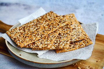 Crispy gluten free crackers with seeds . Healthy whole grain snack 