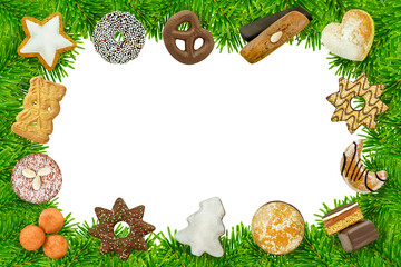 Gemischte Kekse und Süssigkeiten für Weihnachten mit Tannenzweigen auf weissem Hintergrund