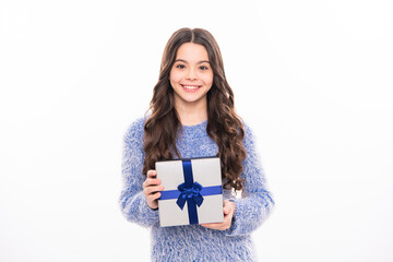 Excited funny kid child girl holding gift box celebrating happy New Year isolated on white background. Teen celebrating birthday. Merry Christmas presents shopping sale.