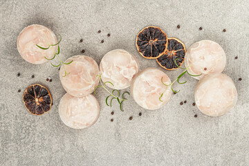 Chunks of frozen hake. Marine fish fillet on stone background, raw ingredient for cooking food