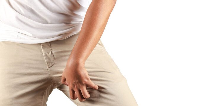 Asian man in reaction of scratching crotch on white background, closeup. Annoying itch or Tinea Cruris. Human body problem or healthcare and medicine concept.