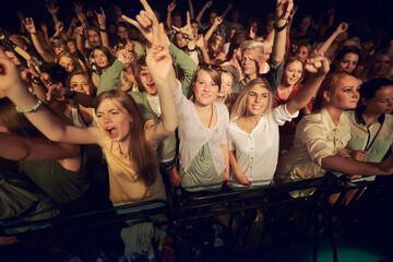 Concert, music festival and crowd with rock hands sign for singing, dance and night event,...