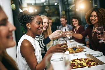 Fotobehang Kruidenier Diversity, dinner and group of people toast celebration together at party. Friends, happy and celebrate with food, wine and friendship for love, support and cheers champagne at business function  © Mikolette M/peopleimages.com