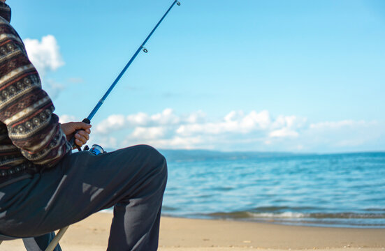 Senior or Middle-aged man fishing at the beach.  ビーチで釣りをするシニアまたは中高年の男性