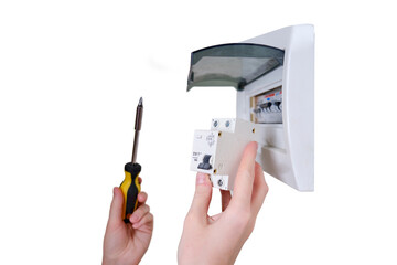 A woman changes an automatic fuse in a home electrical panel, isolated on a white background. Self...