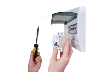 A woman changes an automatic fuse in a home electrical panel, isolated on a white background. Self repair and replacement of electricity equipment in the apartment, diy