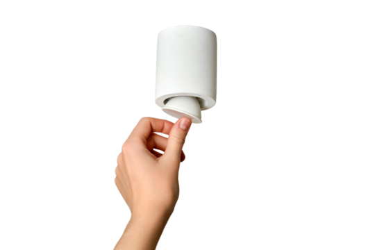 A woman changes a ceiling energy saving light bulb with LED light lamp in a home living room, isolated on a white background. Work at height self, diy