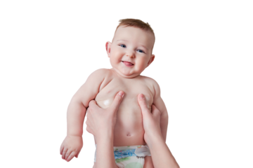 Mother hands are smearing cream on a happy infant baby, isolated on a white background. Mom massages a smiling toddler kid on a sofa, six to seven months old