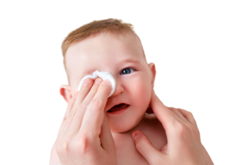 Mother hands wash the eyes of a happy infant baby with a cotton pad, isolated on a white background. Mom holds hygiene face smiling toddler kid on the sofa, six to seven months old