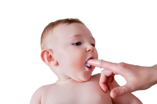 Mother hands brushing teeth with a finger brush of a happy infant baby, isolated on a white background. Mom doing oral hygiene to a smiling toddler kid, six to seven months old