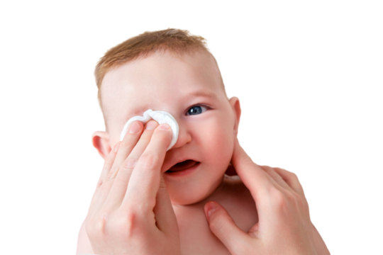 Mother hands wash the eyes of a happy infant baby with a cotton pad, isolated on a white background. Mom holds hygiene face smiling toddler kid on the sofa, six to seven months old