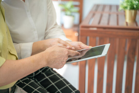 Senior man and woman learnning to use samrt tablet computer for online communication