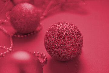 Christmas decorations a on Viva Magenta colored background. The color of 2023.