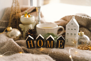 Cozy home. Christmas composition. Hot tea, candles, Christmas golden balls and decorations. Sweet home. Home concept.