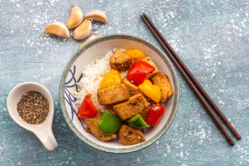Food healthy stir fried chicken add sweet pepper has rice in bowl on blue wood table.