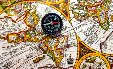 Fototapeta na wymiar The compass lies on an ancient world map.