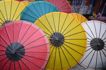 Colorful mulberry paper umbrellas are sold at souvenir shops. White, yellow, red, orange, blue handmade umbrellas made from dyed mulberry paper are used to protect the sun and decorate the place.
