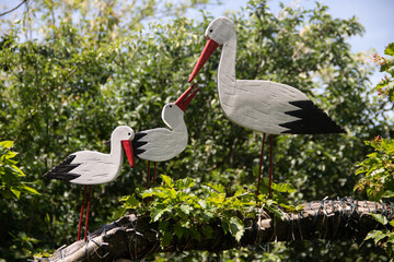Wooden storks as an decoration in backyard of country side weekend house