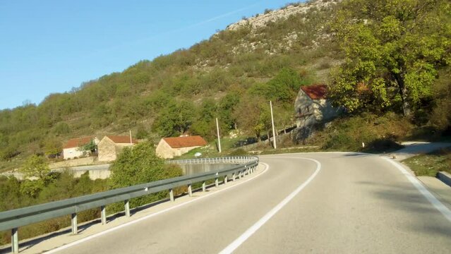 Driving along a street in Montenegro on a sunny day in autumn. Time lapse