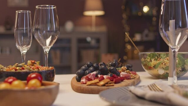 No people shot of dining table set up with wineglasses and meals ready for New Year Eve dinner party