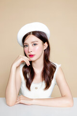 Cute Asian woman with perfect clear fresh skin. Pretty girl model wearing white beret and natural...
