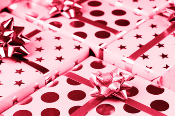 Composition of wrapped Christmas gift boxes with bows and ribbon. Festive decoration concept. Color trend year 2023.