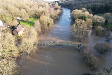 Flooded fields and houses river Severn in Ironbridge England drone aerial view.
