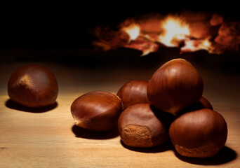 Fire behind a batch of chestnuts on a table