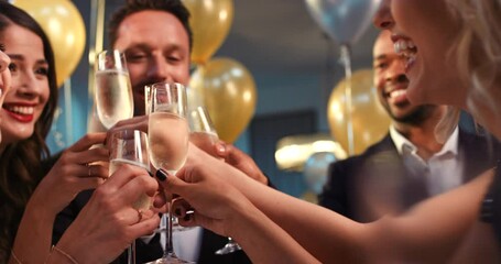 Friends, toast champagne and party with diversity, smile and happiness in night with balloons in home. Multicultural group, people celebration and happy with wine, glass and social success in house