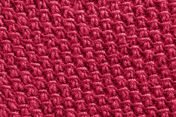Fototapeta na wymiar Trendy color of the year 2023. Texture patterned knit fabric toned in viva magenta color